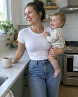 Mother holding her baby, smooth waistline under a fitted tee