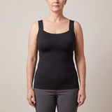 Woman wearing a black vest top with built-in bra cups – non-wired bra vest, no underband